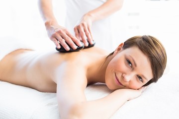 Fototapeta na wymiar Portrait of woman receiving hot stone massage