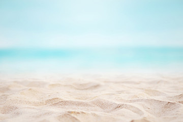Close up sand with blurred sea sky background, summer day, copy space or for product. Summer background concept. - obrazy, fototapety, plakaty