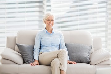 Portrait of smiling senior woman on sofa