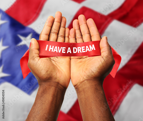 Martin Luther King Day. Male hands on Flag of United States of America background
