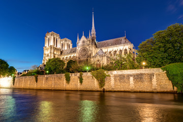 The river Seine and Notre Dame cathedral in Paris at night