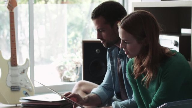 Young couple holding and looking at records