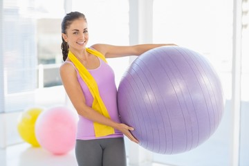 Fototapeta premium Portrait of happy woman holding exercise ball