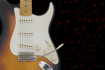 Electric guitar having red notes on a black background.