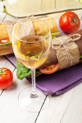 White wine glass and sandwiches