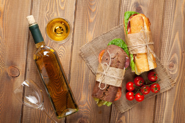 Two sandwiches and white wine