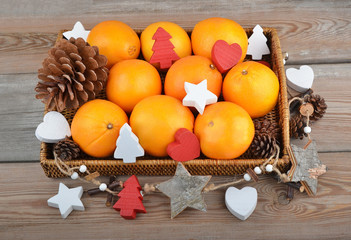 Orange in wickered tray with Christmas decor