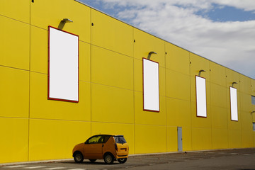 Blank billboards in a yellow wall