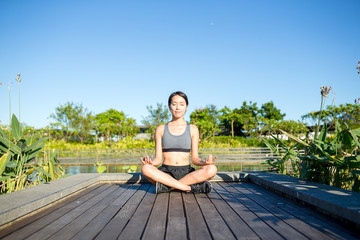 Fototapeta na wymiar Woman sitting in yoga pose