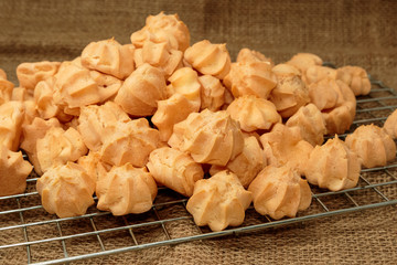 Choux cream in bakery tray on wood table.