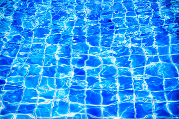 Blue water in swimming pool with sunny reflections.Abstract wate