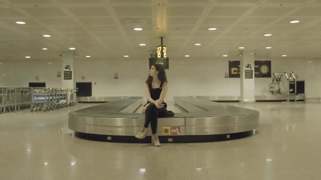 Young Adult Female waiting for luggage in airport