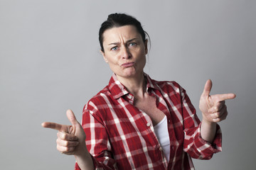 unhappy middle aged woman defending herself with fighting hand gestures