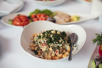 Beautifully decorated catering banquet table with different food snacks and appetizers with sandwich, caviar, fresh fruits on corporate christmas birthday kids party event or wedding celebration