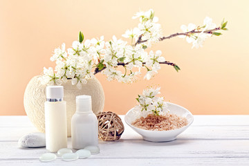 Fototapeta na wymiar Spa treatment with blooming branch on wooden table