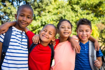 Classmates with arms around at school campus