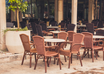 View of empty  terrace of open-air cafe with tables and chairs in old town of Budva. Montenegro.