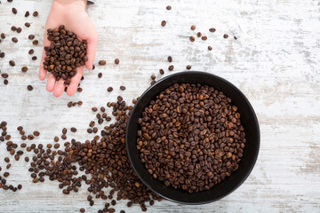 A womans hand at a table with coffee	