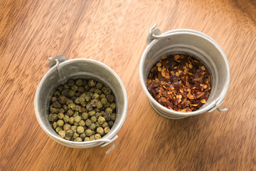 Red and green pepper on wood table