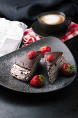 Chocolate cake with strawberries and cup of coffee