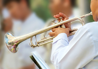 Music / Close up trumpeter blowing the trumpet at outdoor concert.