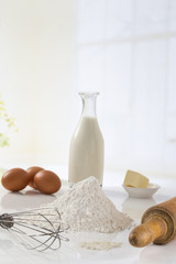 eggs, flour, milk, butter and kitchen utensils