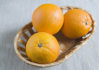 ripe oranges in a basket