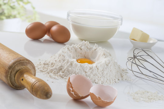 eggs, flour, milk, butter and kitchen utensils