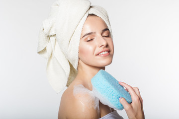 Girl in shower holding wisp with foam