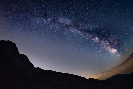 The outstanding beauty of the Milky Way arc and the starry sky captured at high altitude in summertime on the Italian Alps, Torino Province. Fisheye scenic distortion and 180 degree view.