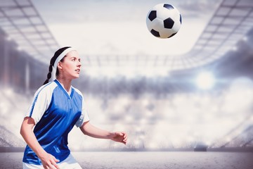Composite image of woman soccer player waiting the ball