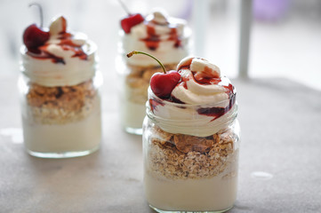 Yogurt with muesli and strawberry on a wooden table