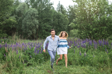 Naklejka na ściany i meble happy young couple man and woman walking in nature, concept of l