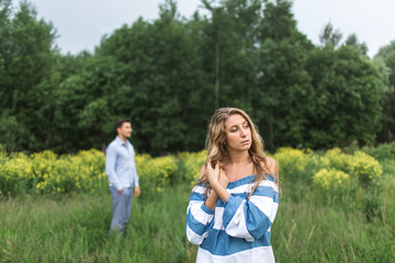 happy young couple man and woman walking in nature