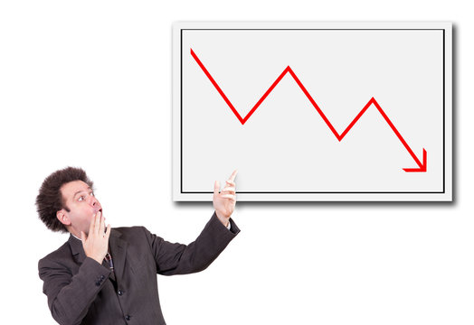 Shocked man in a suit shows a hand on the board with a declining arrow. Businessman has the shock of rapid decline in stocks.