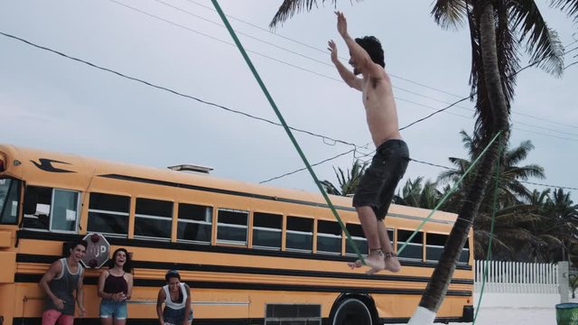 Man balancing on slackline at beach