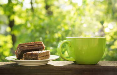 large green cup and two cakes on the plate