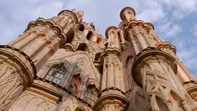 Low angle pan of the Parroquia in the Jardin in San Miguel de Allende