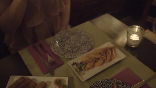 Young Adult Women eating tapas in restaurant