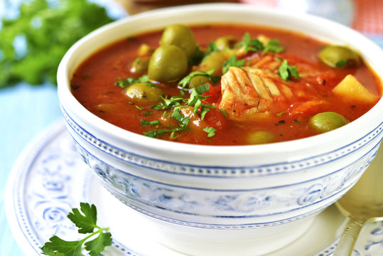 Tomato soup with cod,potato and olives.