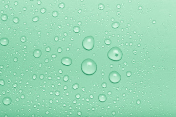 Drops of water on a color background. Green. Toned