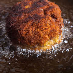 Cutlet fried in oil in a frying pan. Selective focus