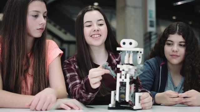 Female Children working with small robot at school