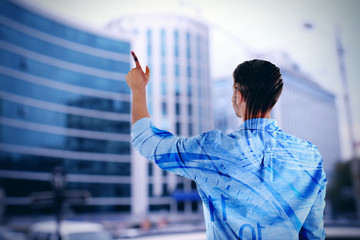 Back view of young man pointing on abstract blur background, double exposition