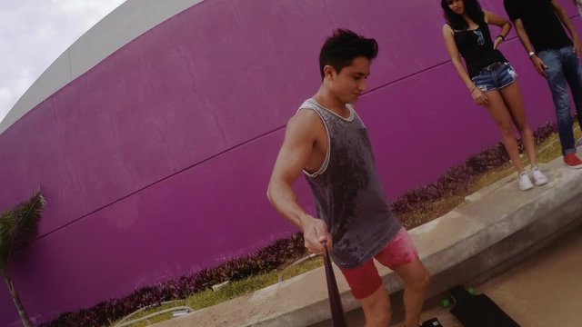 Man enjoying monopod and playing skateboarding at street