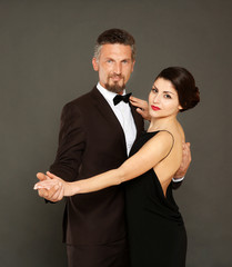 Happy mature couple on dark background