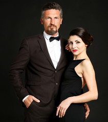 Happy mature couple on dark background