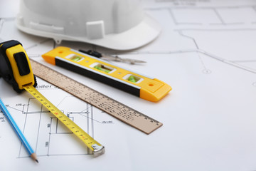 Construction drawing with helmet and other tools closeup