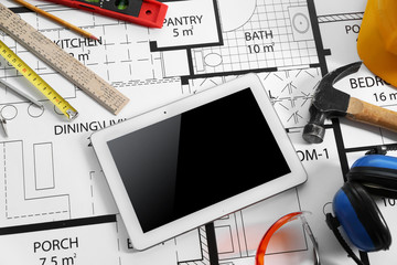 Construction drawing with tools and tablet closeup