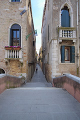 Venice, Italy, June, 21, 2016: narrow medieval street in Venice, Italy